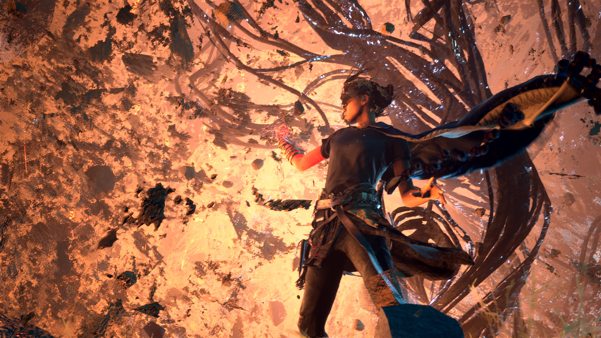 Frey being held by her arms and head by some cables.